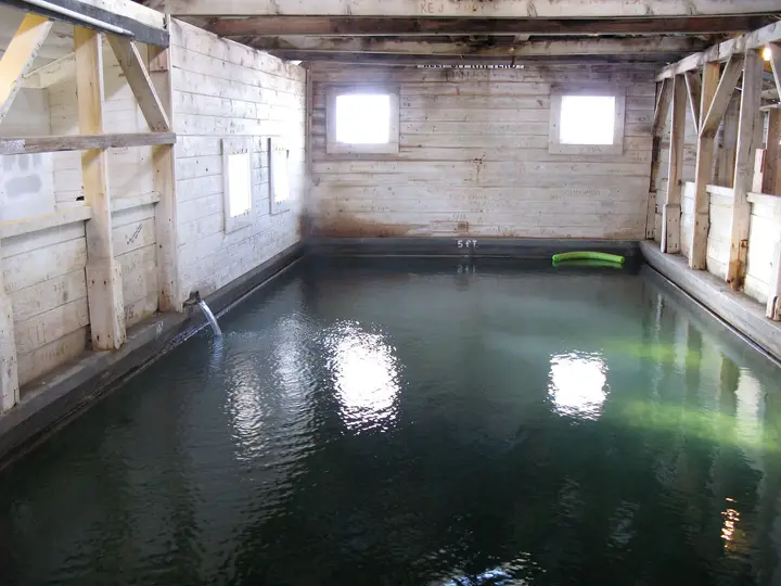 Indoor hot spring pool inside the wooden 1929 bathhouse at Summer Lake Hot Springs
