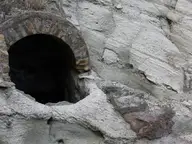 Arched bathing niche carved into the volcanic tuff cliff at Terme di Cavascura