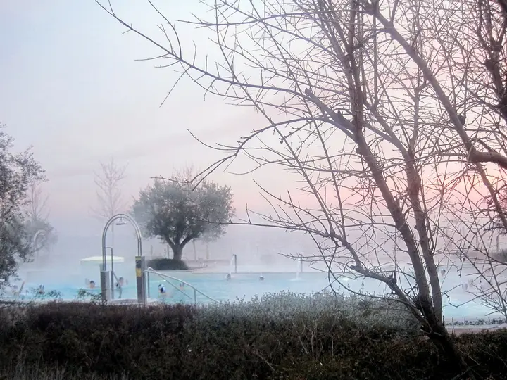 Steam rising from the outdoor thermal pool at Terme di Sirmione on a misty morning