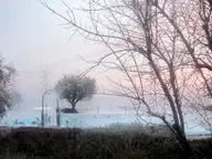Steam rising from the outdoor thermal pool at Terme di Sirmione on a misty morning