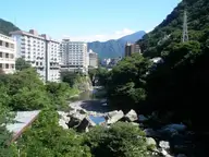 Hotels above the rocky Kinugawa River gorge at Kinugawa Onsen under blue sky