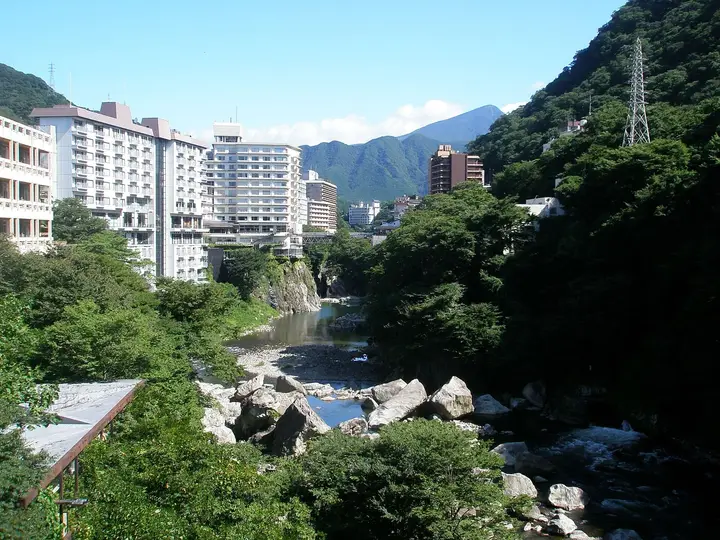 Hotels above the rocky Kinugawa River gorge at Kinugawa Onsen under blue sky