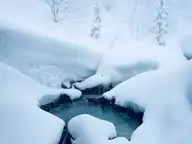 Snow covered outdoor bath of Magoroku Onsen in the Nyuto Onsenkyo valley