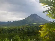 Arenal Volcano rising over rainforest, seen from The Springs Resort and Spa