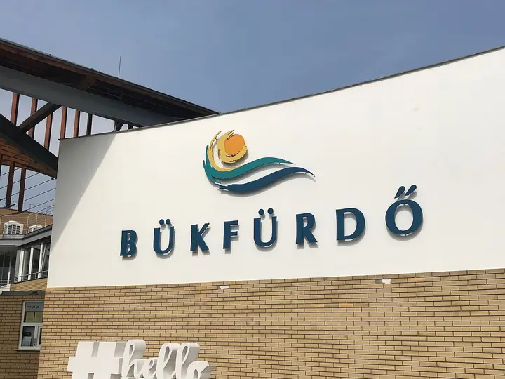 Entrance building of Bükfürdő Thermal and Spa with the Bükfürdő logo and large letter sign