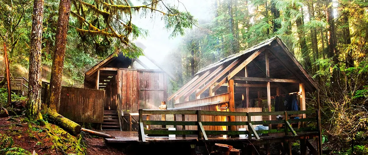 Steam rising from the wooden bathhouse decks at Bagby Hot Springs in old growth forest