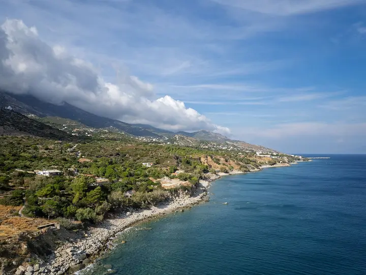 Aerial view of the rocky southern Ikaria coastline west of Agios Kirykos under clouds