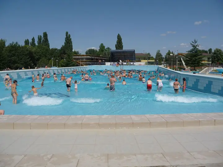 Outdoor wave pool with blue water at the Zsóry thermal bath in Mezőkövesd