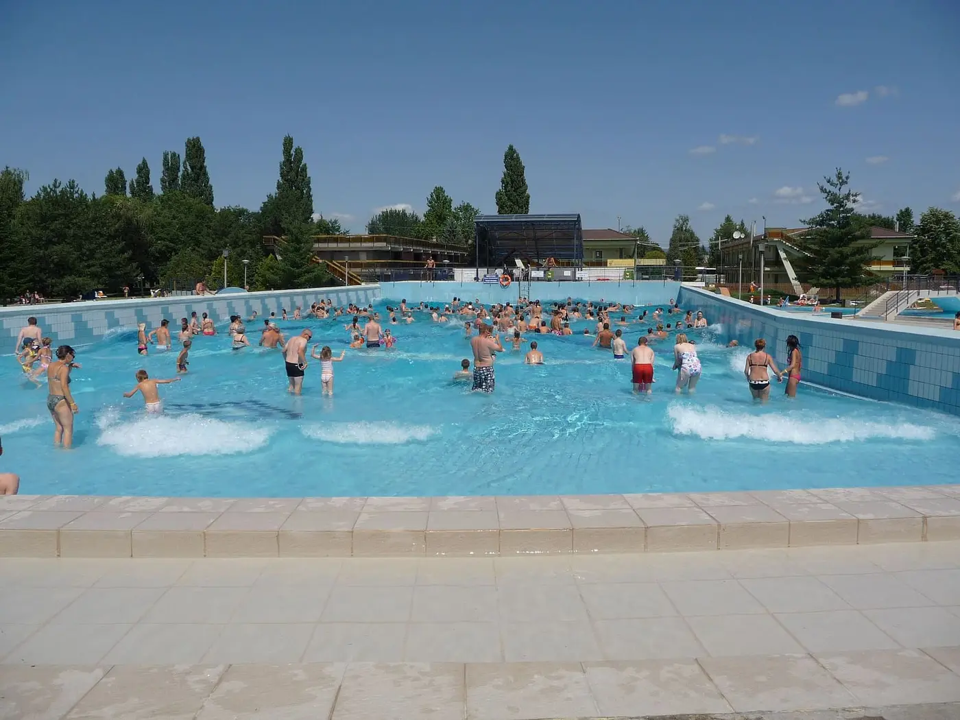 Outdoor wave pool with blue water at the Zsóry thermal bath in Mezőkövesd